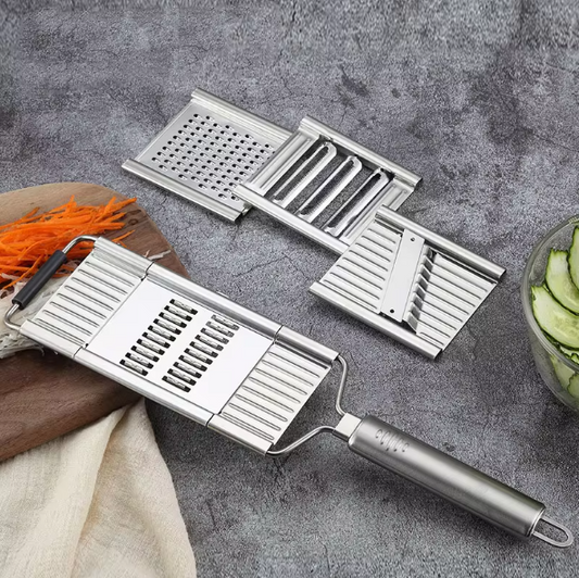 Multifunctional stainless steel vegetable grater cutter slicer with different blades on a gray surface.