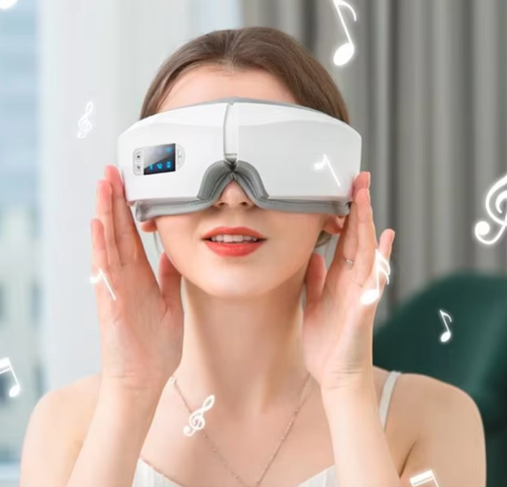 Woman wearing a white eye massager with a blurred background